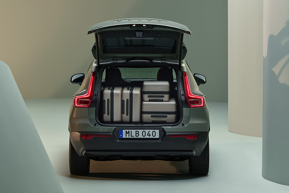 The trunk of a Volvo XC40 is open and filled with luggage